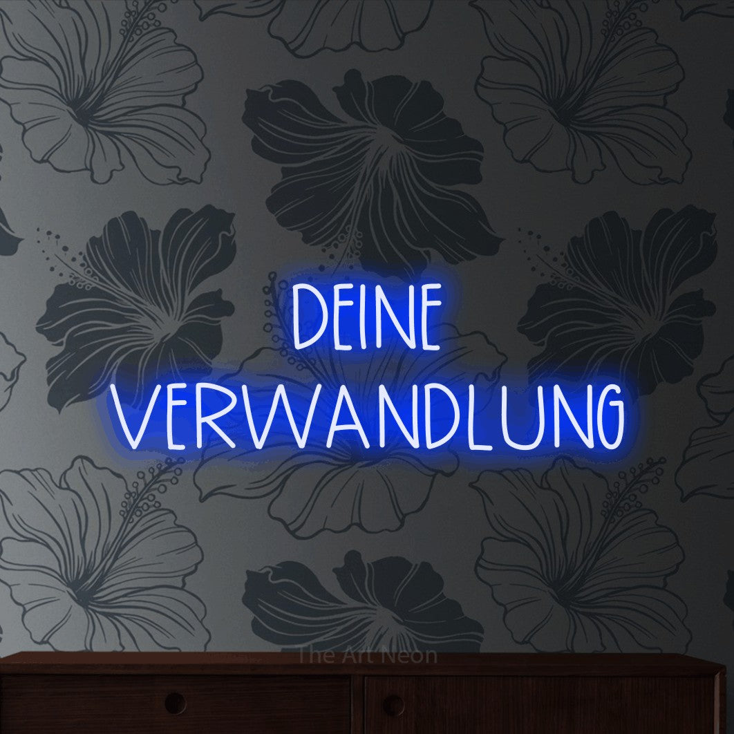 LED neon sign reading “DEINE VERWANDLUNG”, arranged in 2 lines.