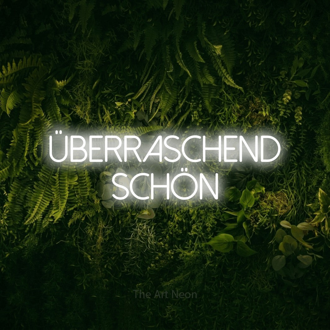 LED neon sign reading “ÜBERRASCHEND SCHÖN”, arranged in 2 lines.