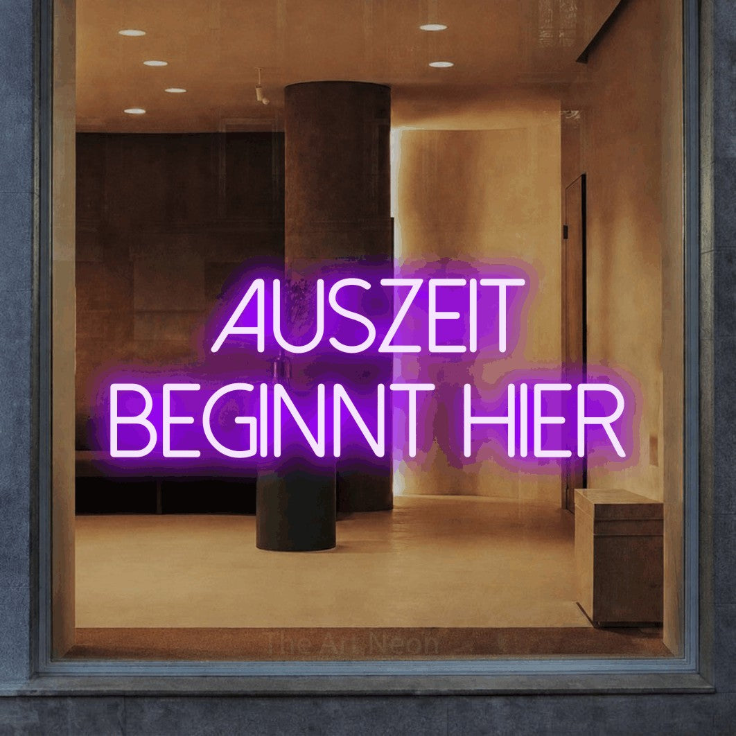 LED neon sign reading “Auszeit beginnt hier”, arranged in 2 lines.