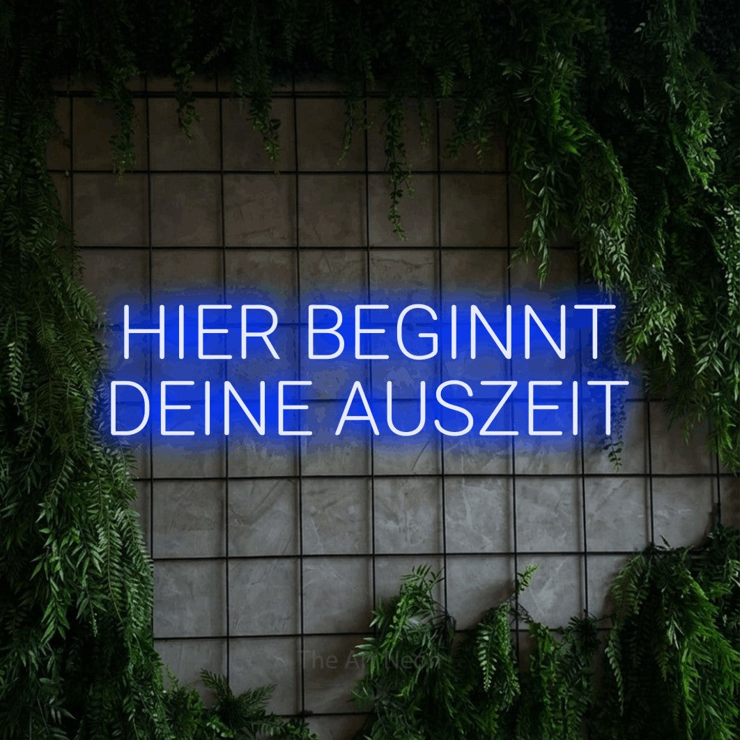 LED neon sign reading “HIER BEGINNT DEINE AUSZEIT”, arranged in 2 lines.