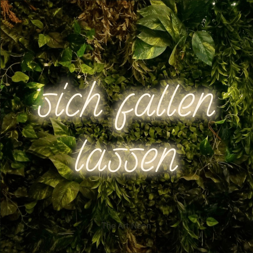 LED neon sign displaying “sich fallen lassen”.