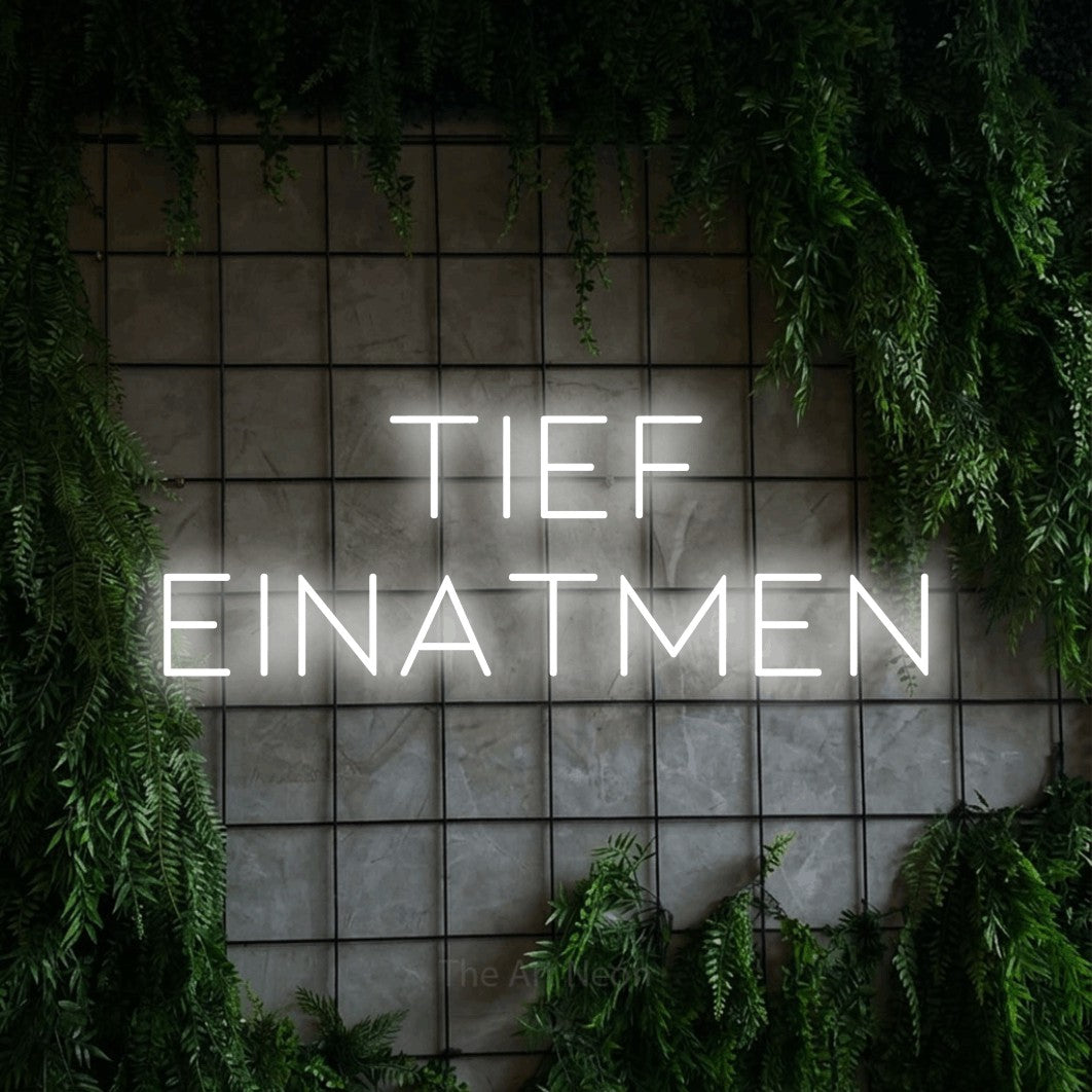 LED neon sign reading “TIEF EINATMEN”, arranged in 2 lines.