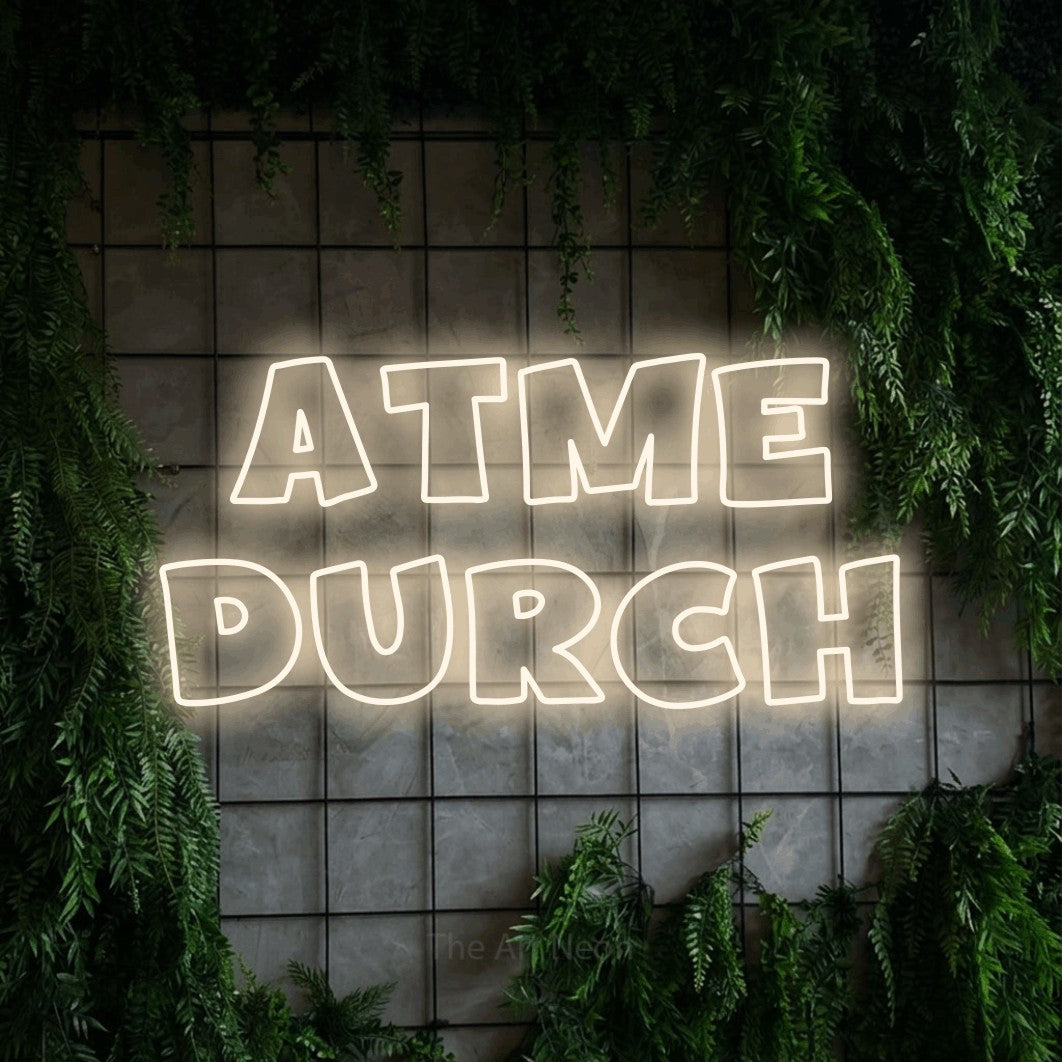 LED neon sign reading “atme DURCH”, arranged in 2 lines.