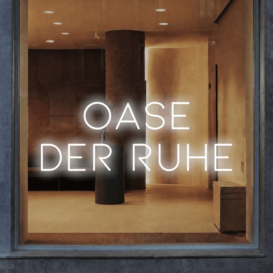 LED neon sign reading “Oase der Ruhe”, arranged in 2 lines.