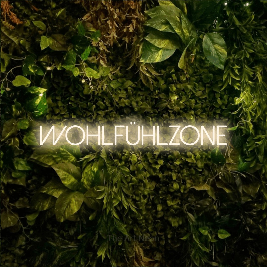 LED neon sign reading “WOHLFÜHLZONE”, arranged in a single line.