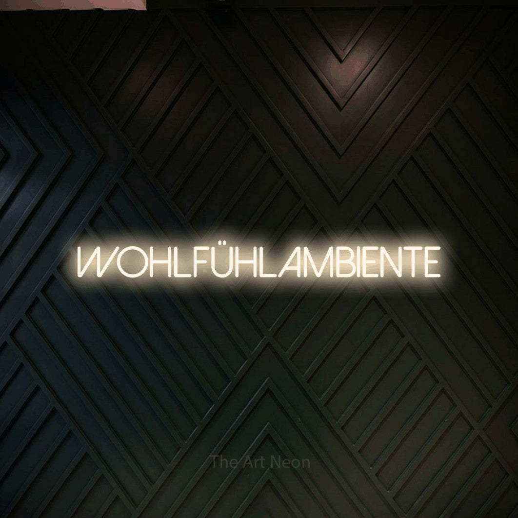 LED neon sign reading “Wohlfühlambiente”, arranged in a single line.