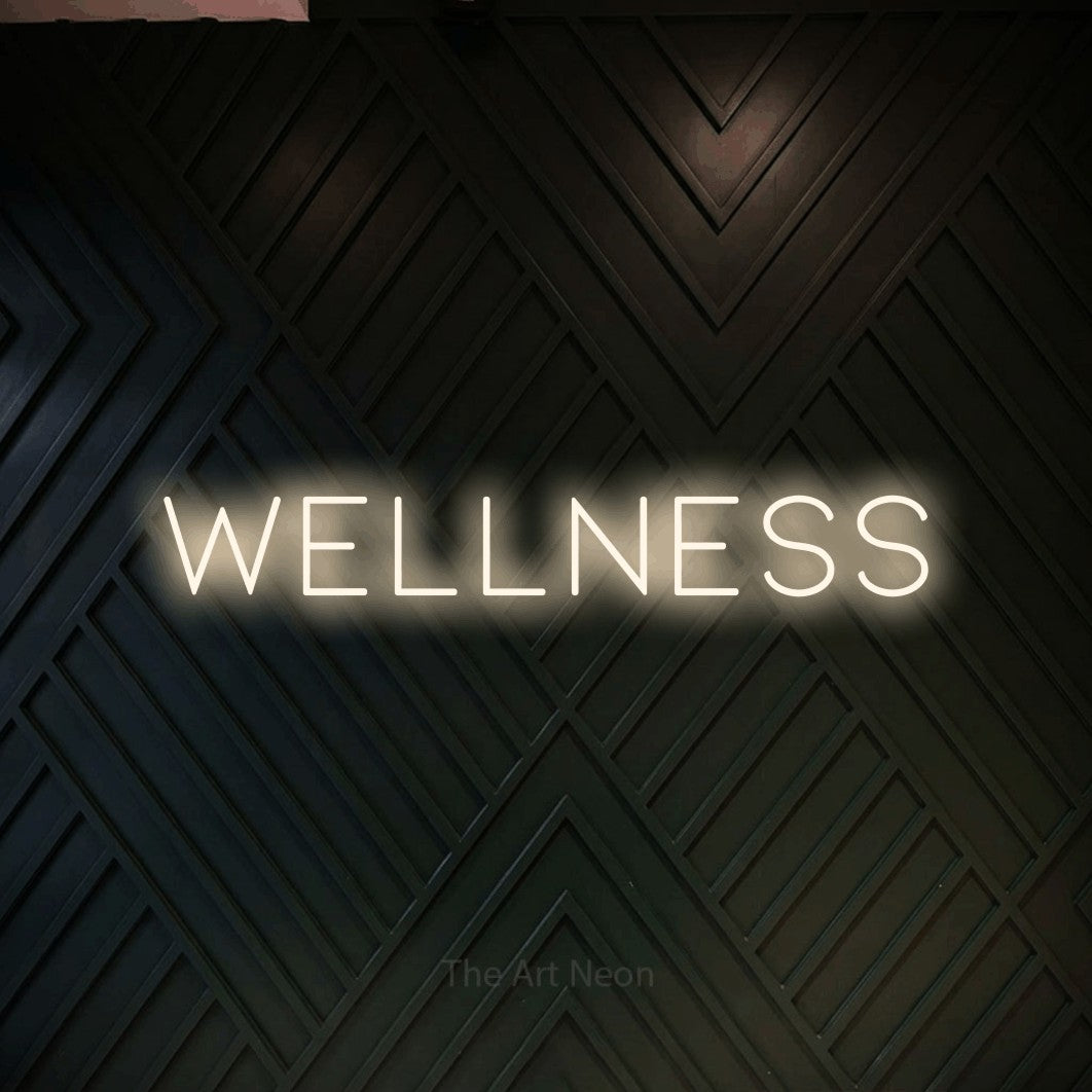 LED neon sign reading “Wellness”, arranged in a single line.