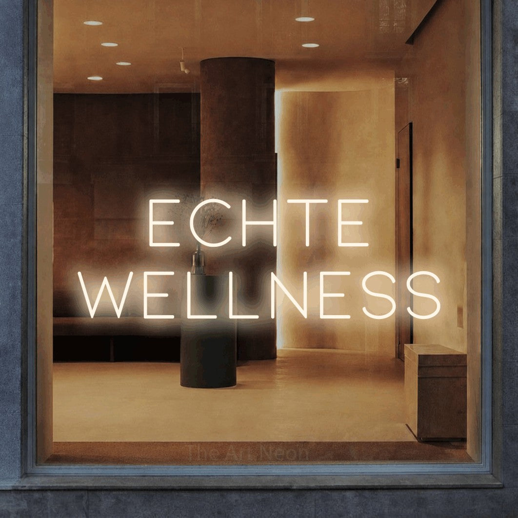 LED neon sign reading “Echte Wellness”, arranged in 2 lines.