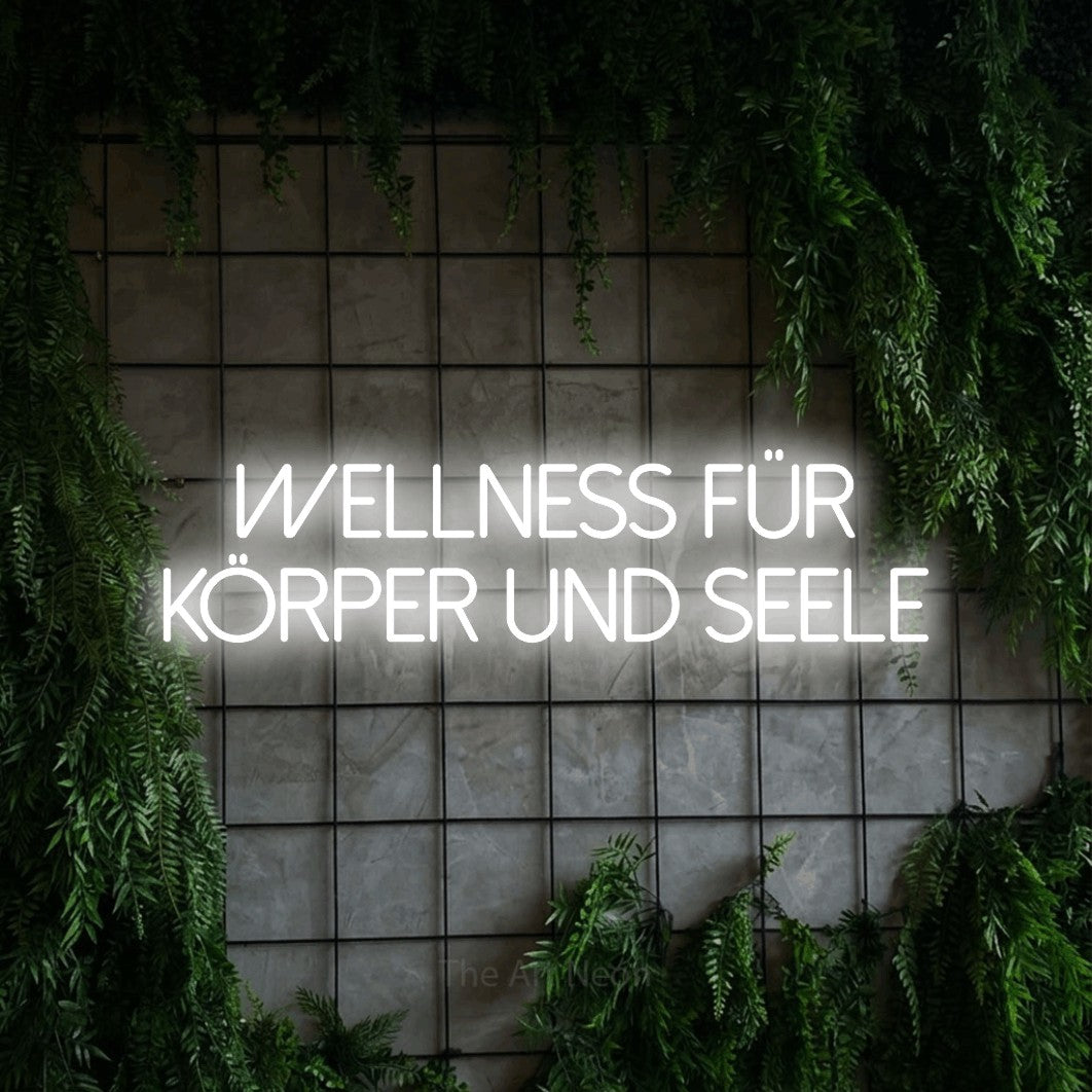LED neon sign reading “Wellness für Körper und Seele”, arranged in 2 lines.