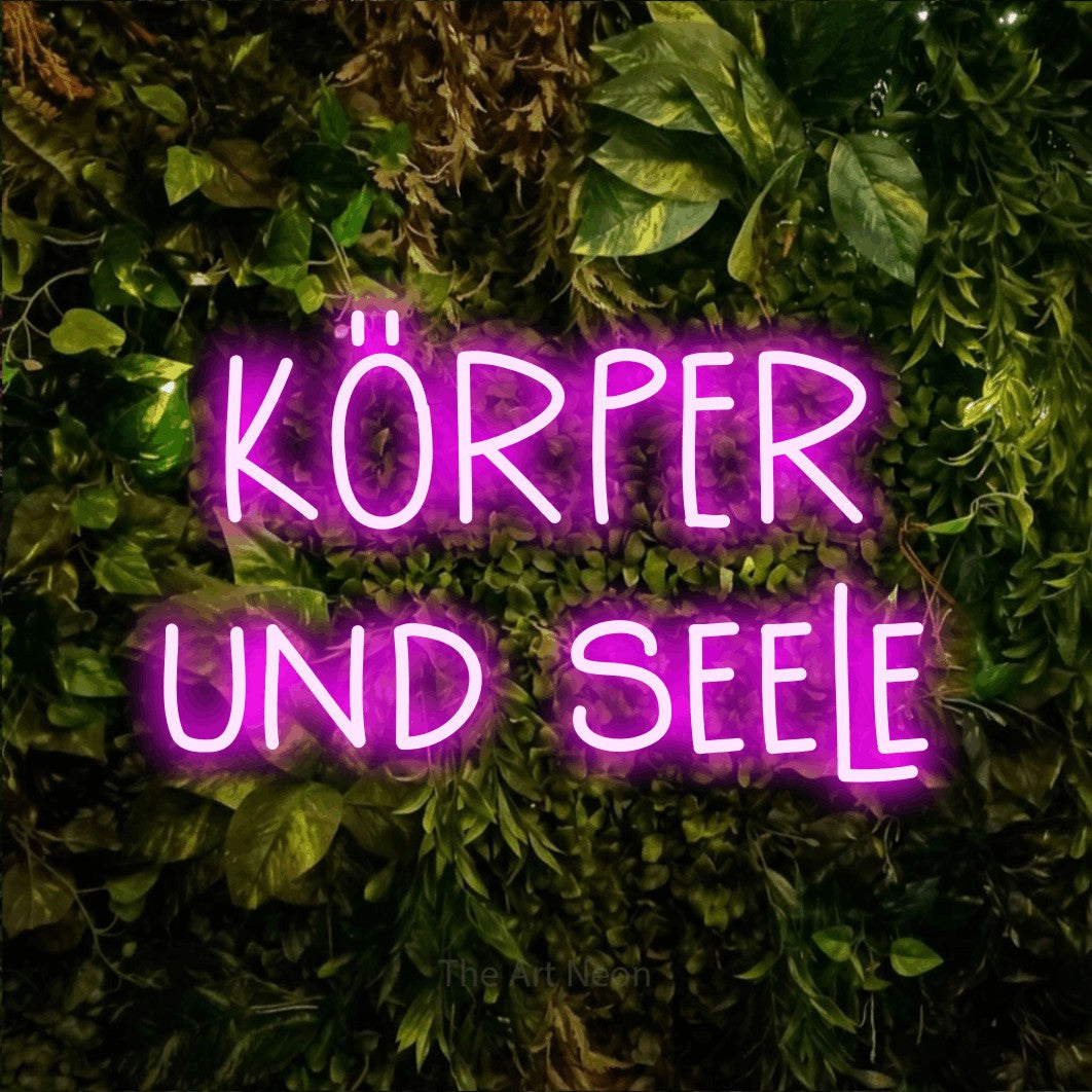 LED neon sign reading “KÖRPER und seele”, arranged in 2 lines.