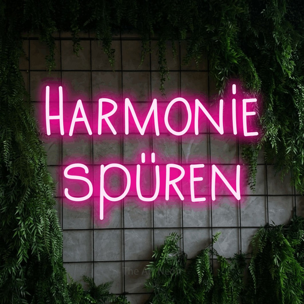 LED neon sign reading “Harmonie spüren”, arranged in 2 lines.