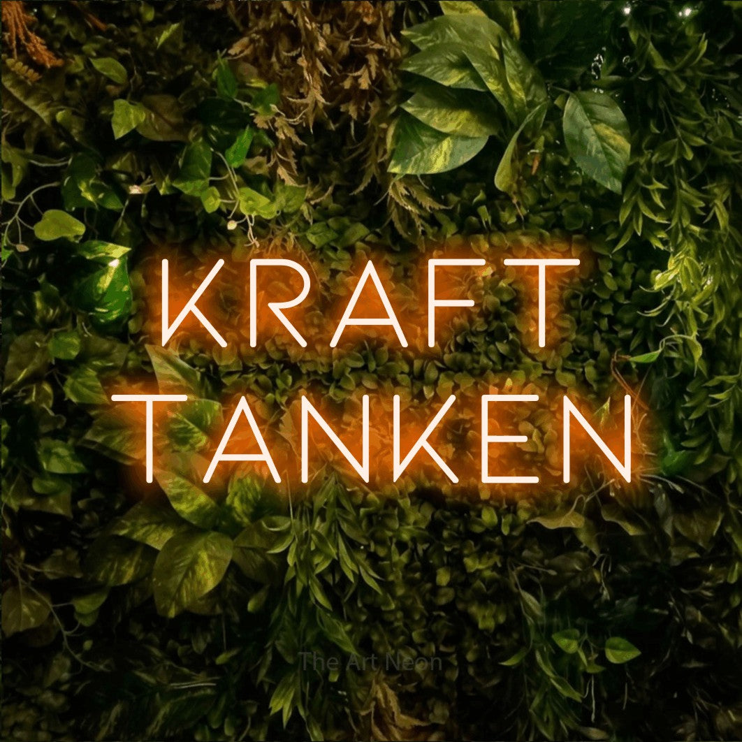 LED neon sign reading “Kraft tanken”, arranged in 2 lines.