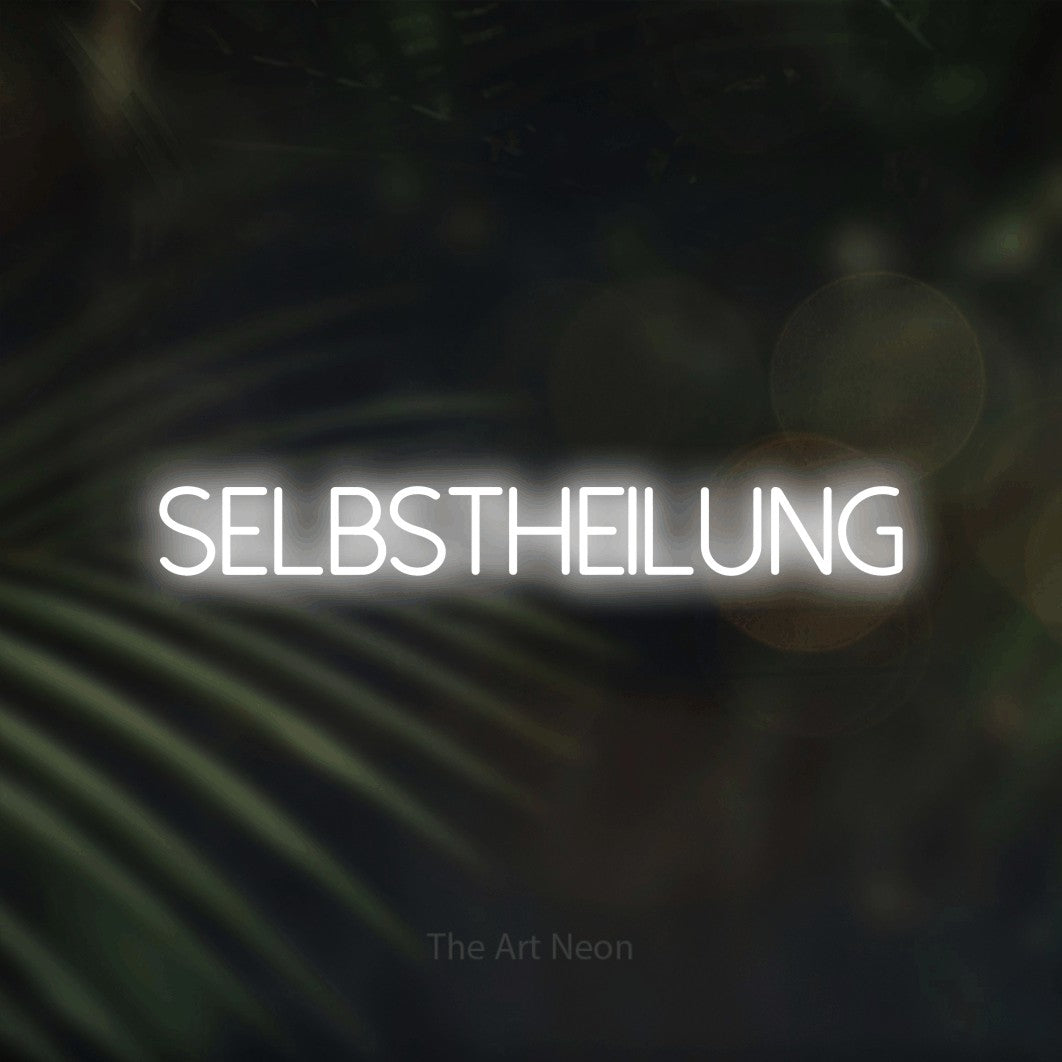 LED neon sign reading “SELBSTHEILUNG”, arranged in a single line.