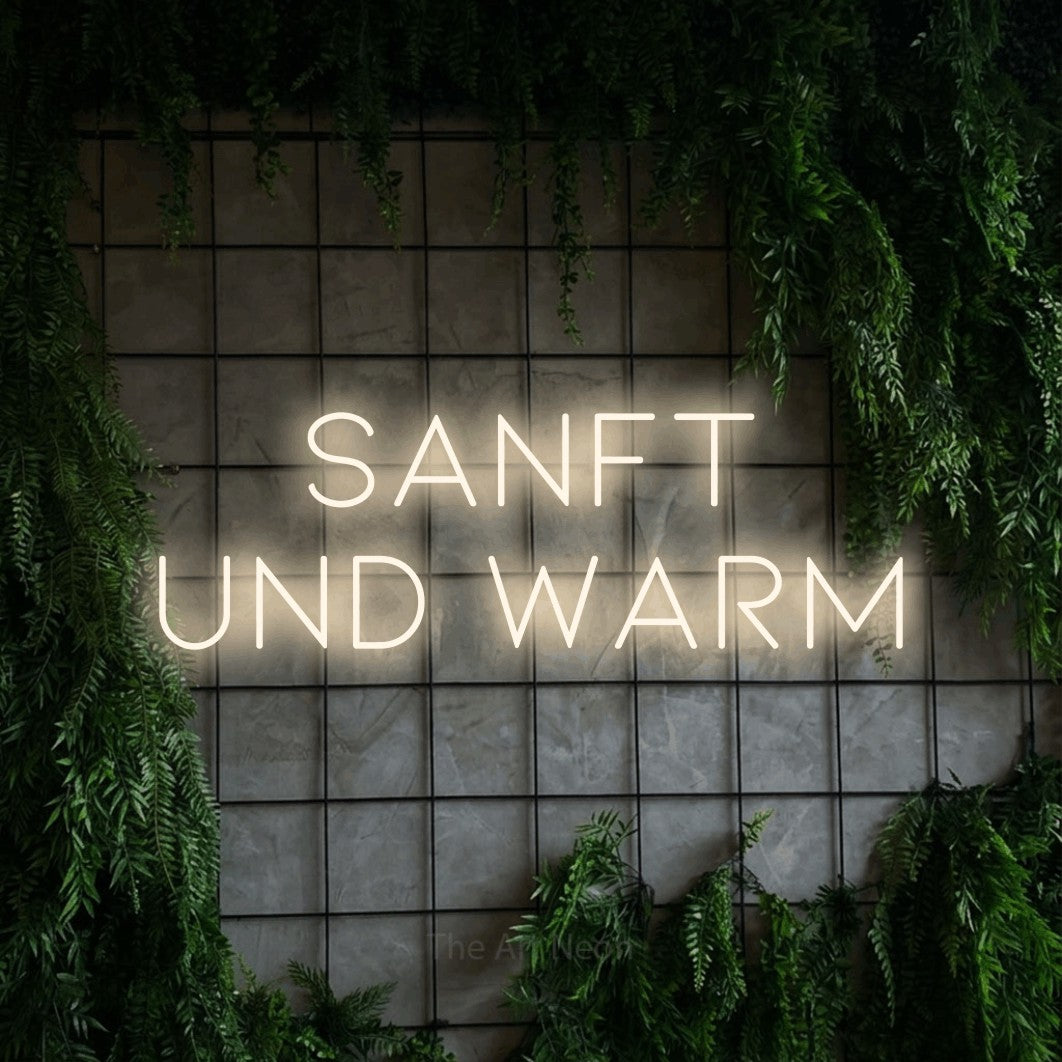 LED neon sign reading “sanft und warm”, arranged in 2 lines.