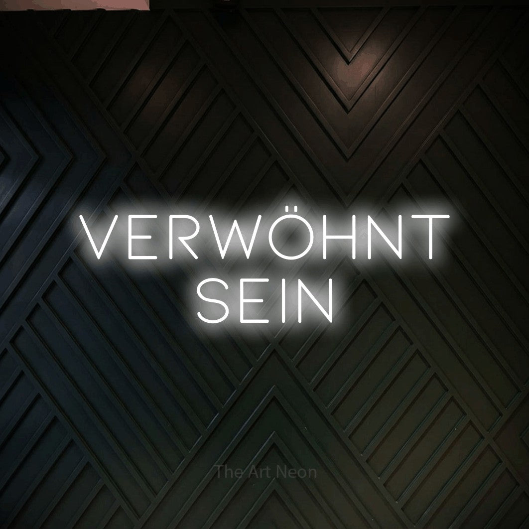 LED neon sign reading “VERWÖHNT sein”, arranged in 2 lines.