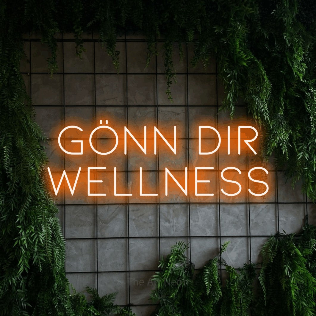 LED neon sign reading “Gönn dir Wellness”, arranged in 2 lines.