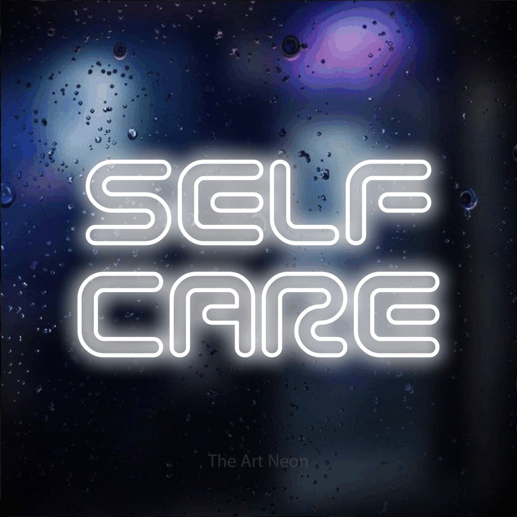 LED neon sign reading “SELF CARE”, arranged in 2 lines.