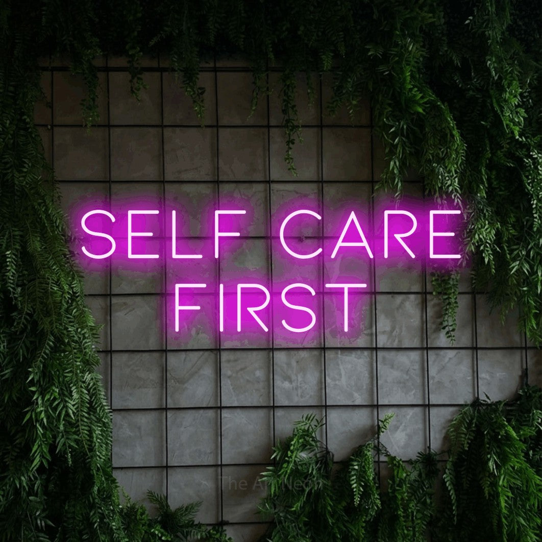 LED neon sign reading “Self Care first”, arranged in 2 lines.