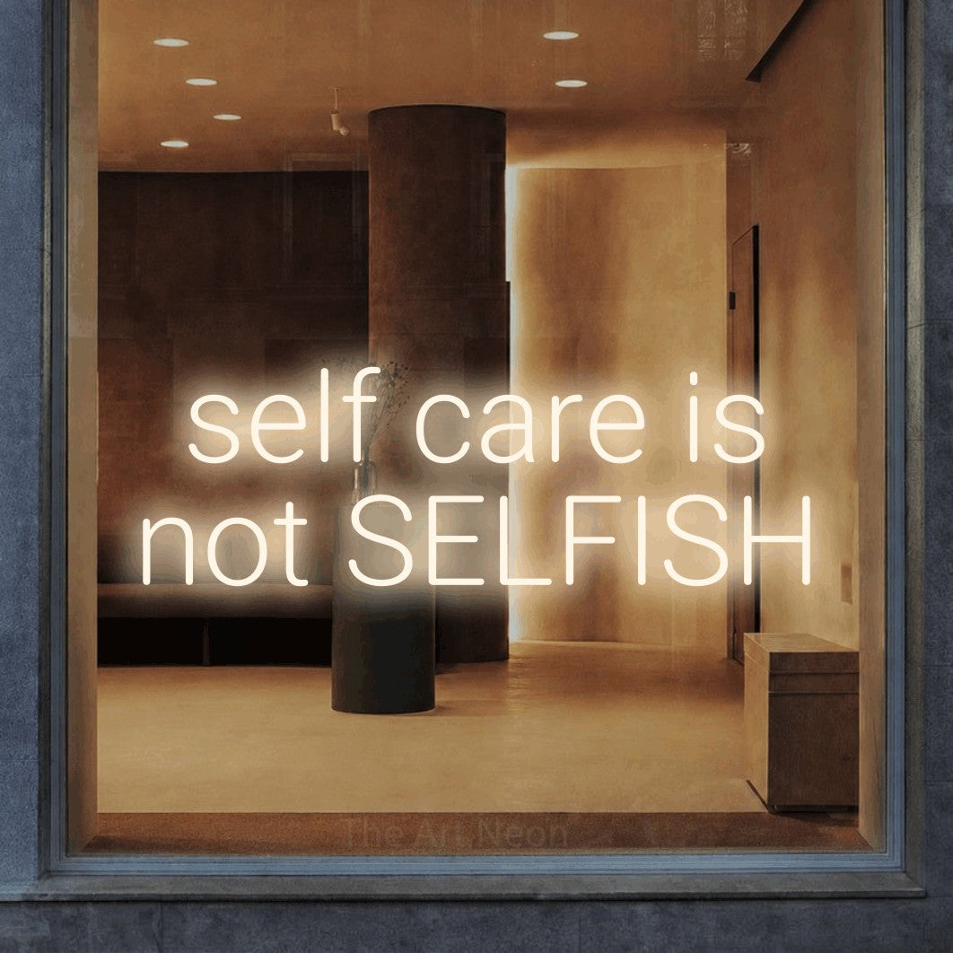 LED neon sign reading “self care is not SELFISH”, arranged in 2 lines.