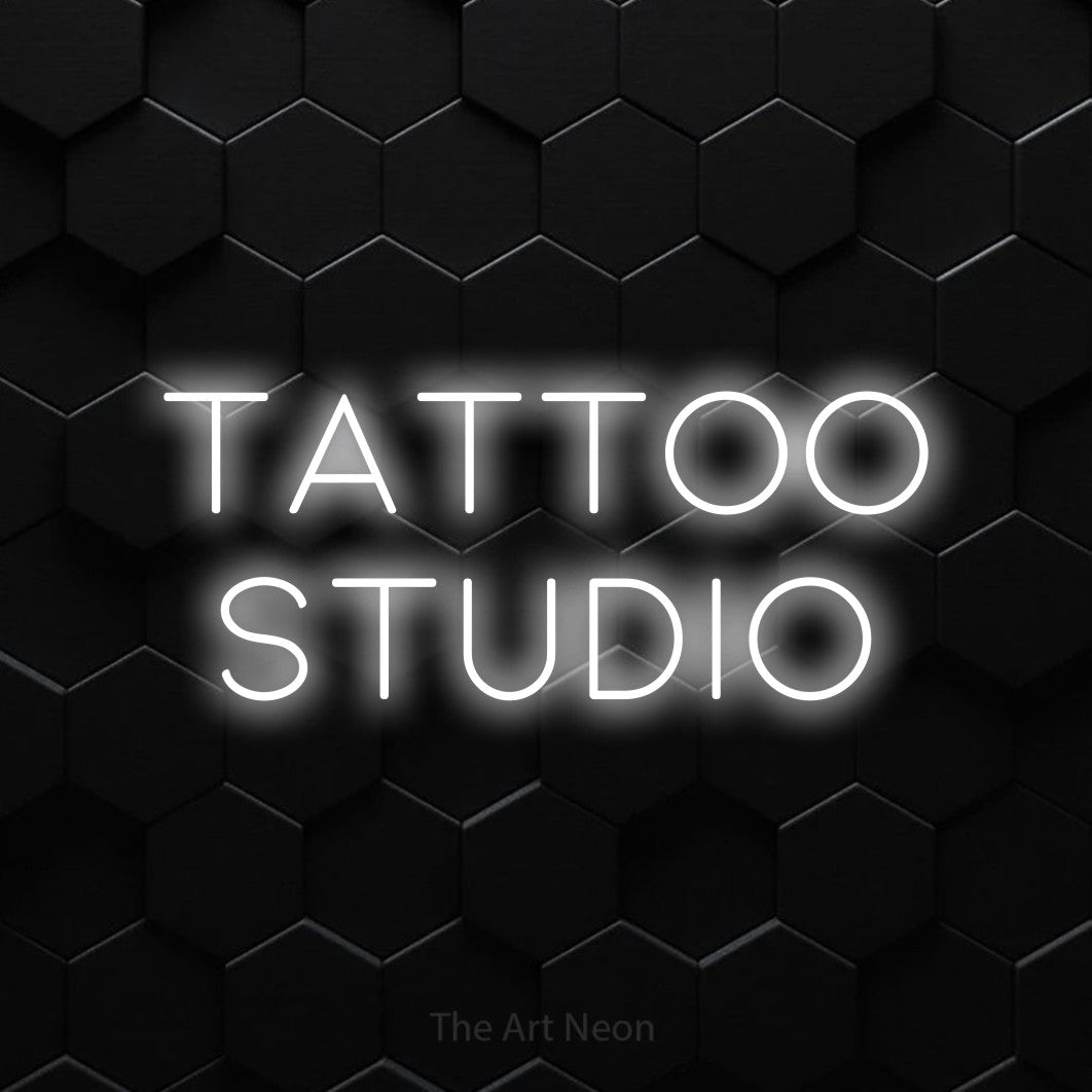 LED neon sign reading “TATTOO studio”, arranged in 2 lines.
