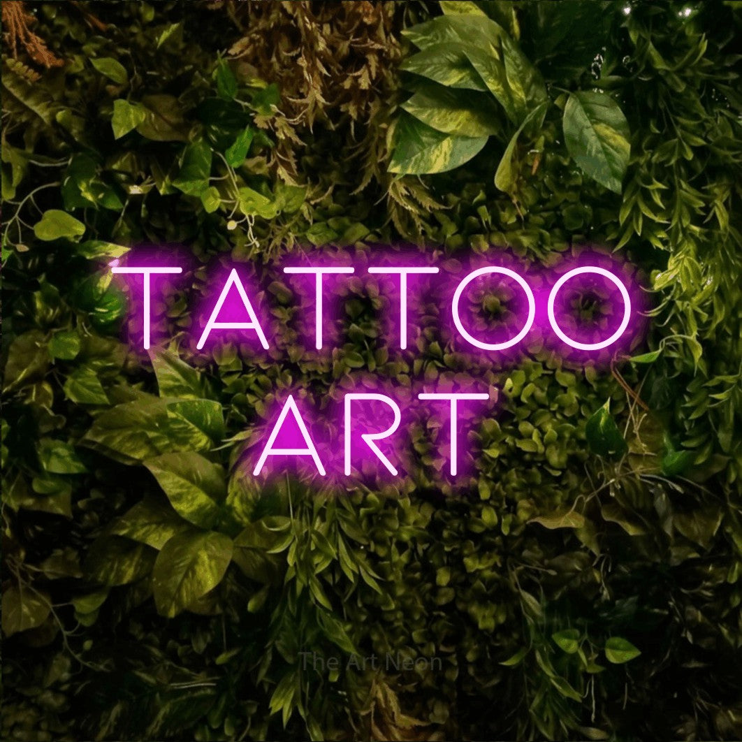 LED neon sign reading “TATTOO art”, arranged in 2 lines.