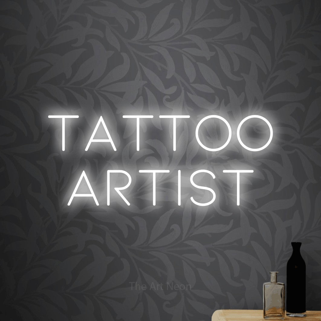 LED neon sign reading “Tattoo Artist”, arranged in 2 lines.