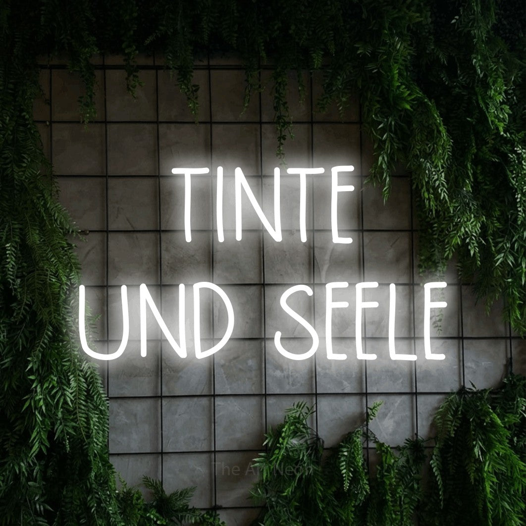 LED neon sign reading “TINTE UND SEELE”, arranged in 2 lines.