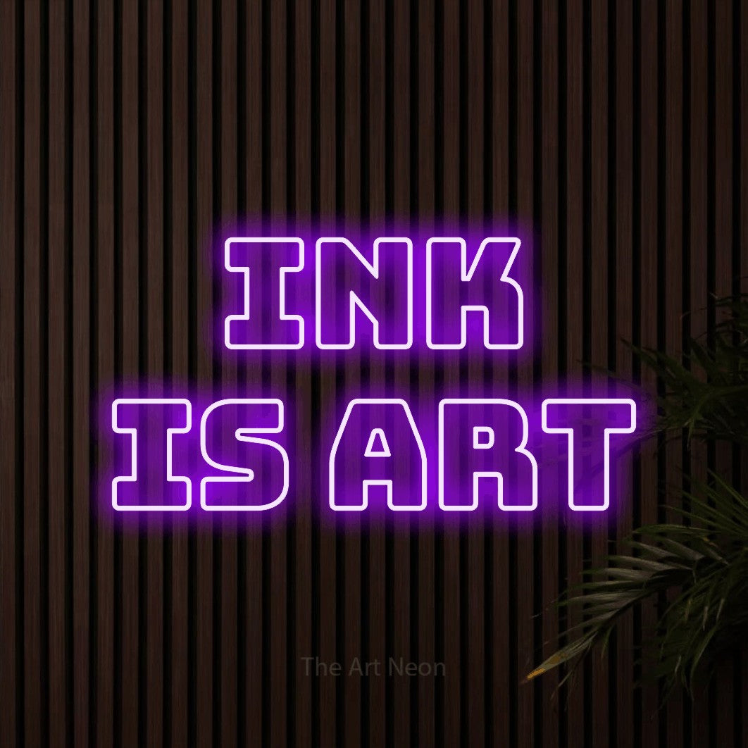 LED neon sign reading “ink is art”, arranged in 2 lines.