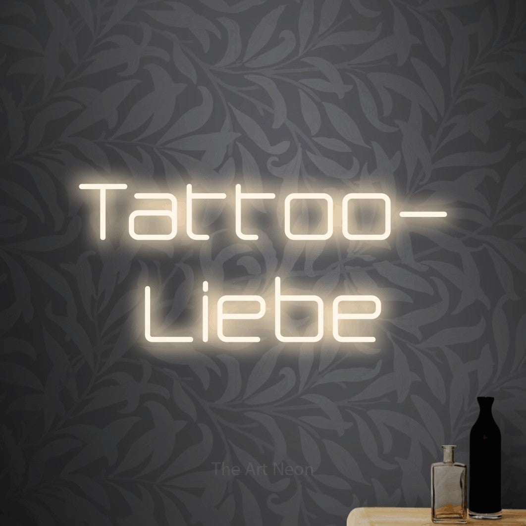 LED neon sign reading “Tattoo- Liebe”, arranged in 2 lines.