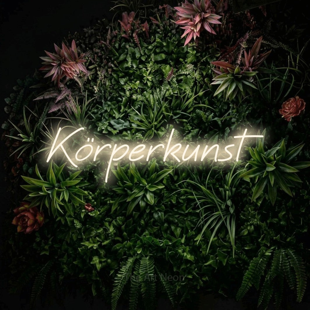 LED neon sign reading “Körperkunst”, arranged in a single line.