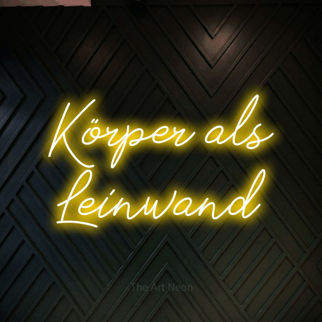 LED neon sign reading “Körper als Leinwand”, arranged in 2 lines.