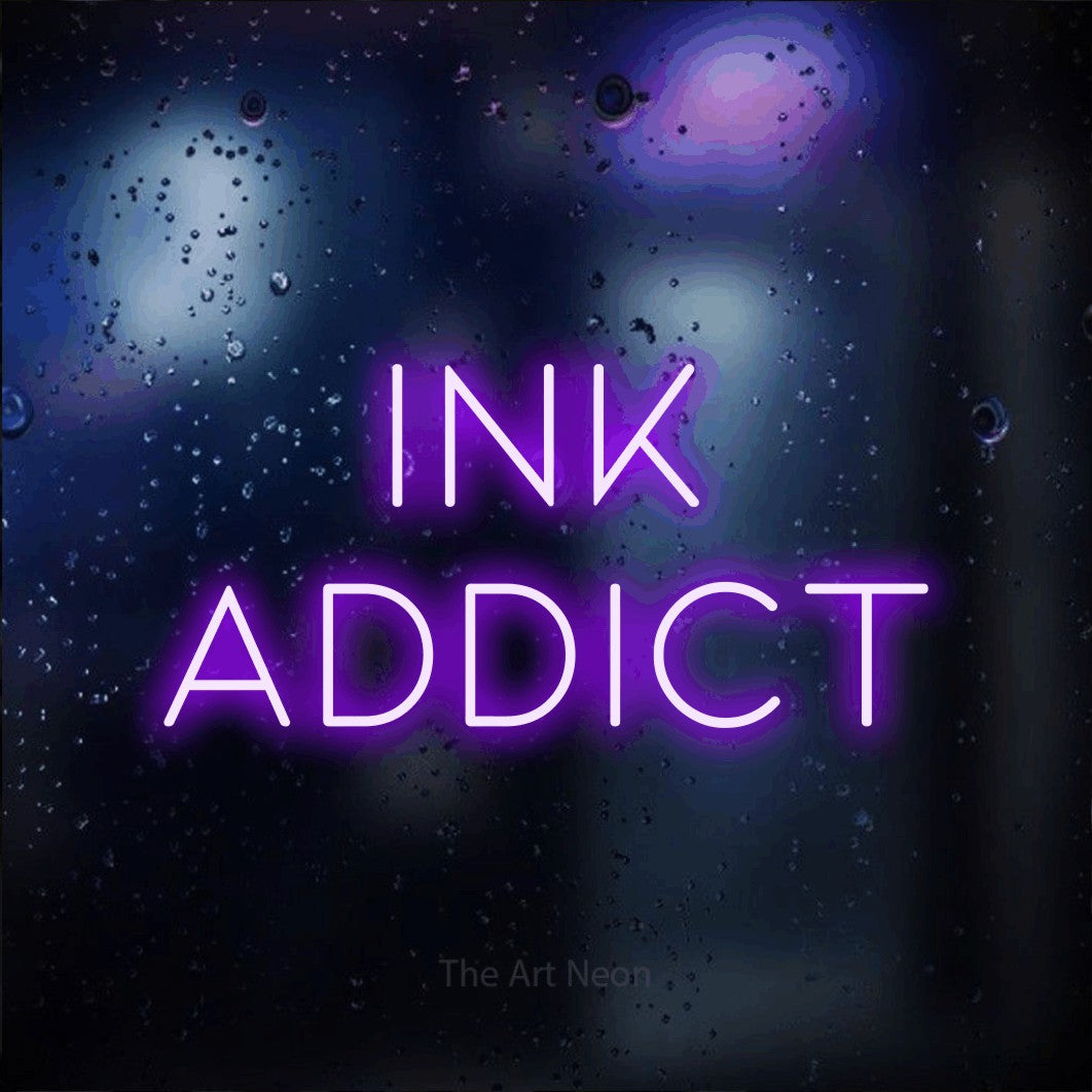 LED neon sign reading “ink addict”, arranged in 2 lines.
