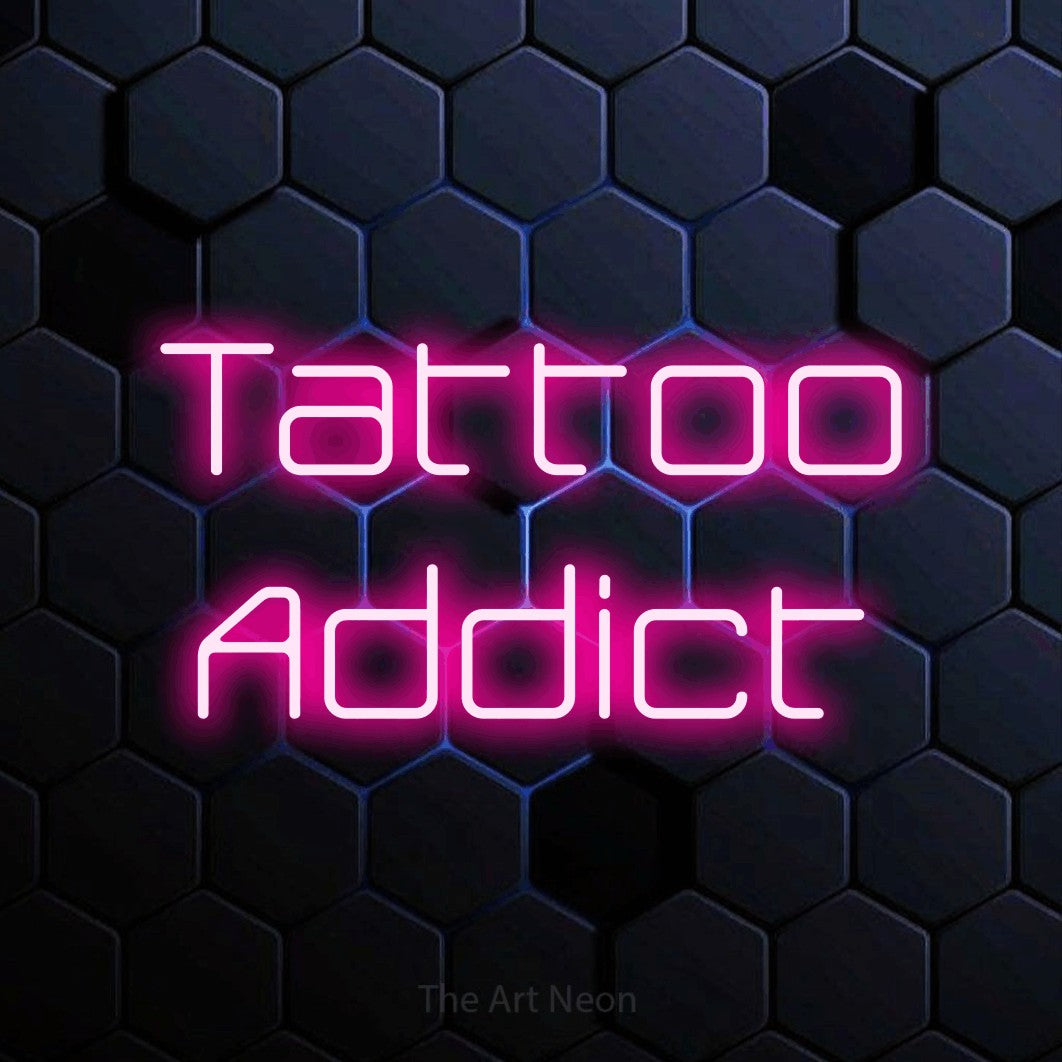 LED neon sign reading “Tattoo Addict”, arranged in 2 lines.