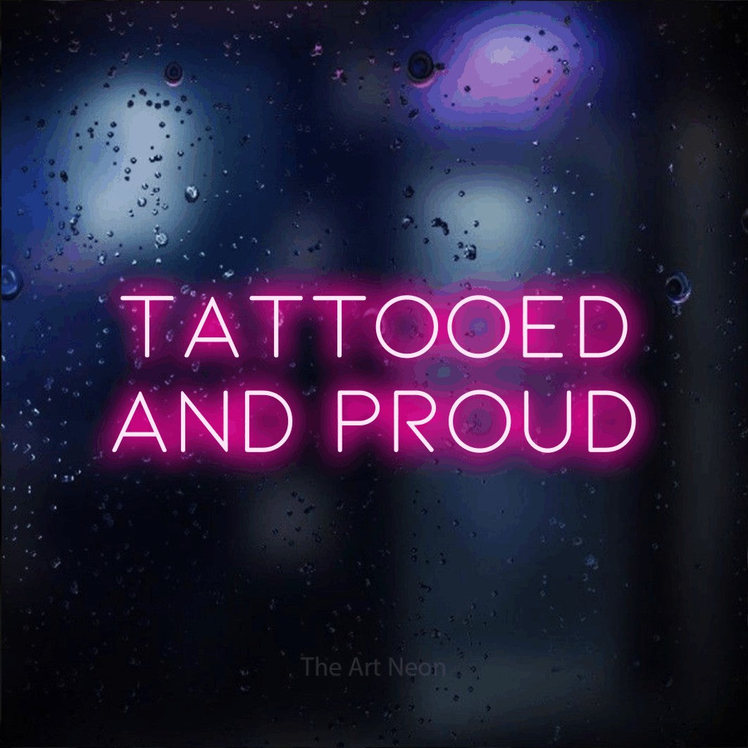 LED neon sign reading “TATTOOED and proud”, arranged in 2 lines.