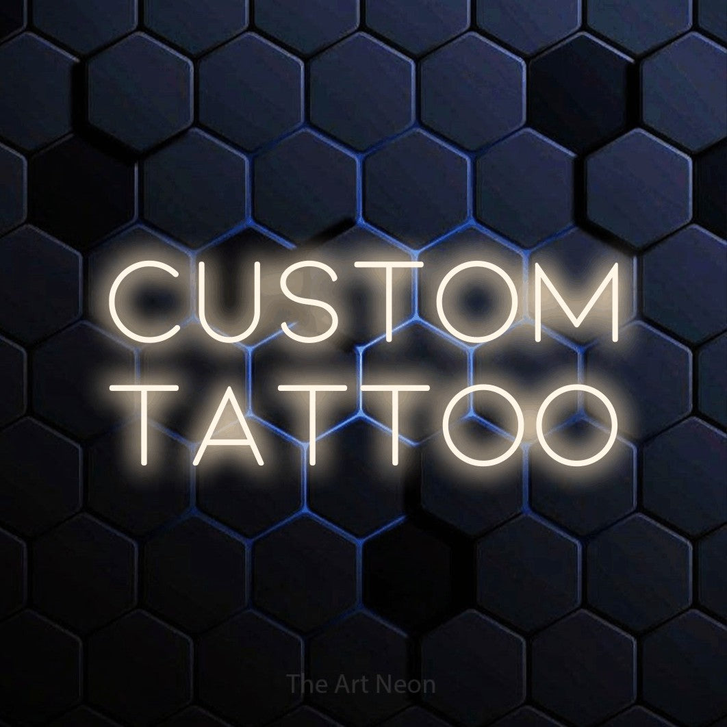LED neon sign reading “custom tattoo”, arranged in 2 lines.