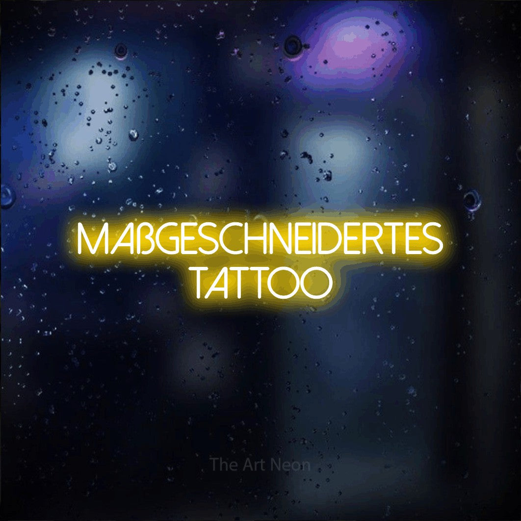 LED neon sign reading “maßgeschneidertes tattoo”, arranged in 2 lines.