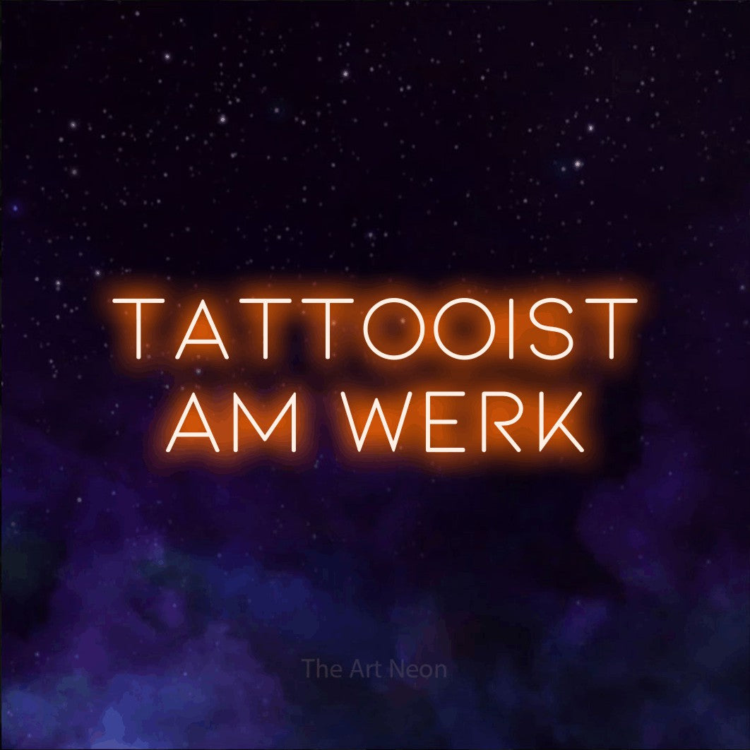 LED neon sign reading “TATTOOIST AM WERK”, arranged in 2 lines.