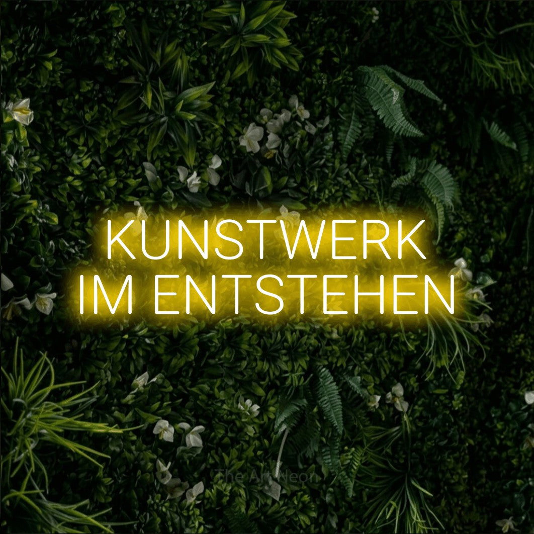 LED neon sign reading “KUNSTWERK IM ENTSTEHEN”, arranged in 2 lines.