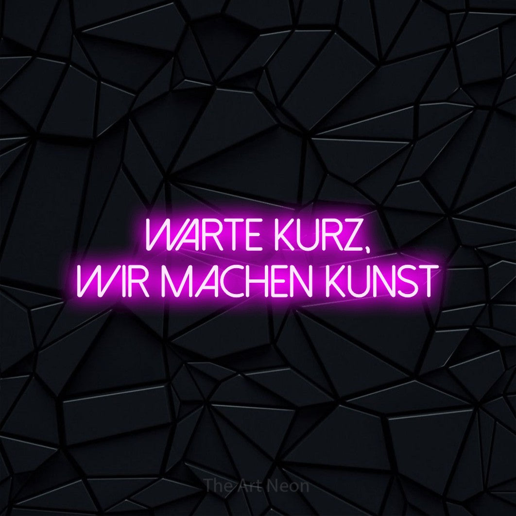 LED neon sign reading “warte kurz, wir machen kunst”, arranged in 2 lines.