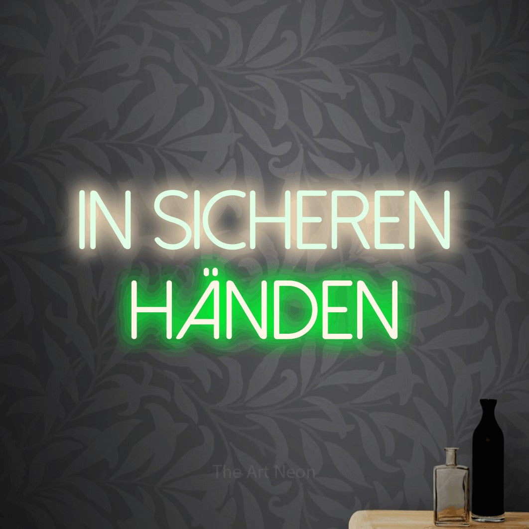 LED neon sign reading “in SICHEREN händen”, arranged in 2 lines.