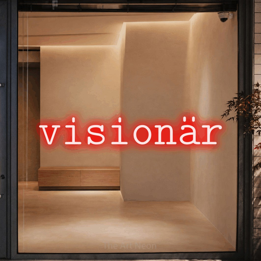 LED neon sign reading “visionär”, arranged in a single line.