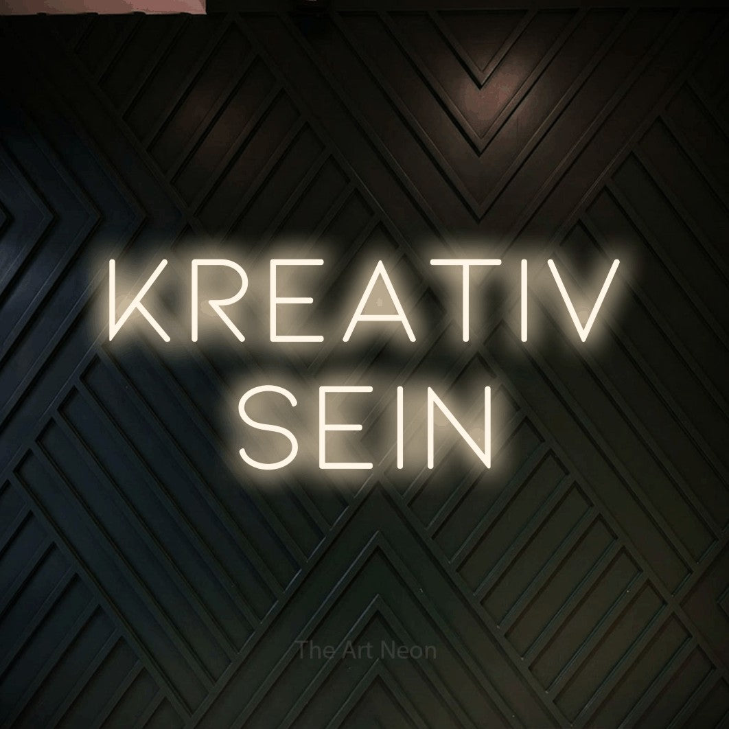 LED neon sign reading “Kreativ sein”, arranged in 2 lines.