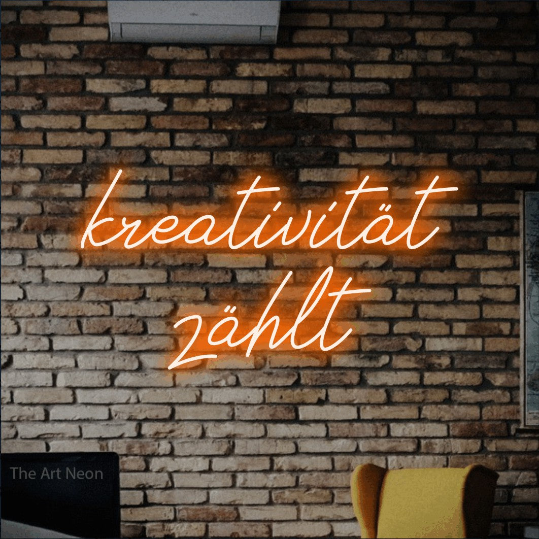 LED neon sign reading “kreativität zählt”, arranged in 2 lines.