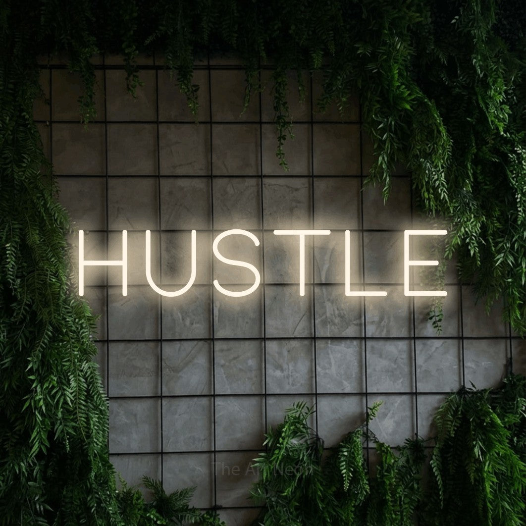 LED neon sign reading “HUSTLE”, arranged in a single line.