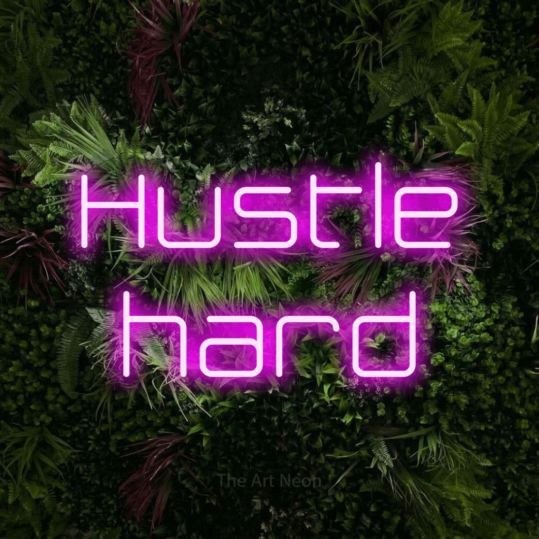 LED neon sign reading “Hustle hard”, arranged in 2 lines.