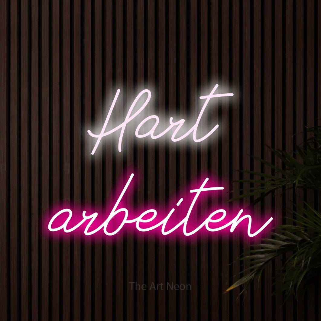 LED neon sign reading “Hart arbeiten”, arranged in 2 lines.