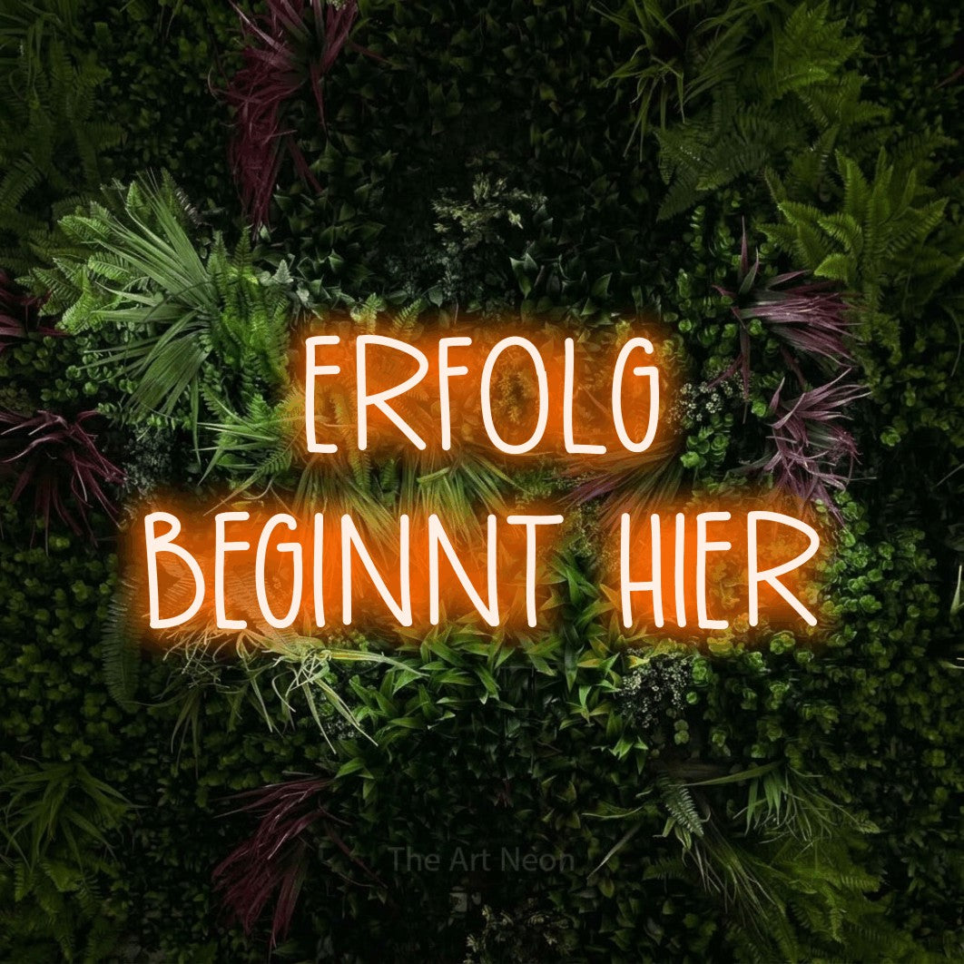 LED neon sign reading “ERFOLG BEGINNT HIER”, arranged in 2 lines.