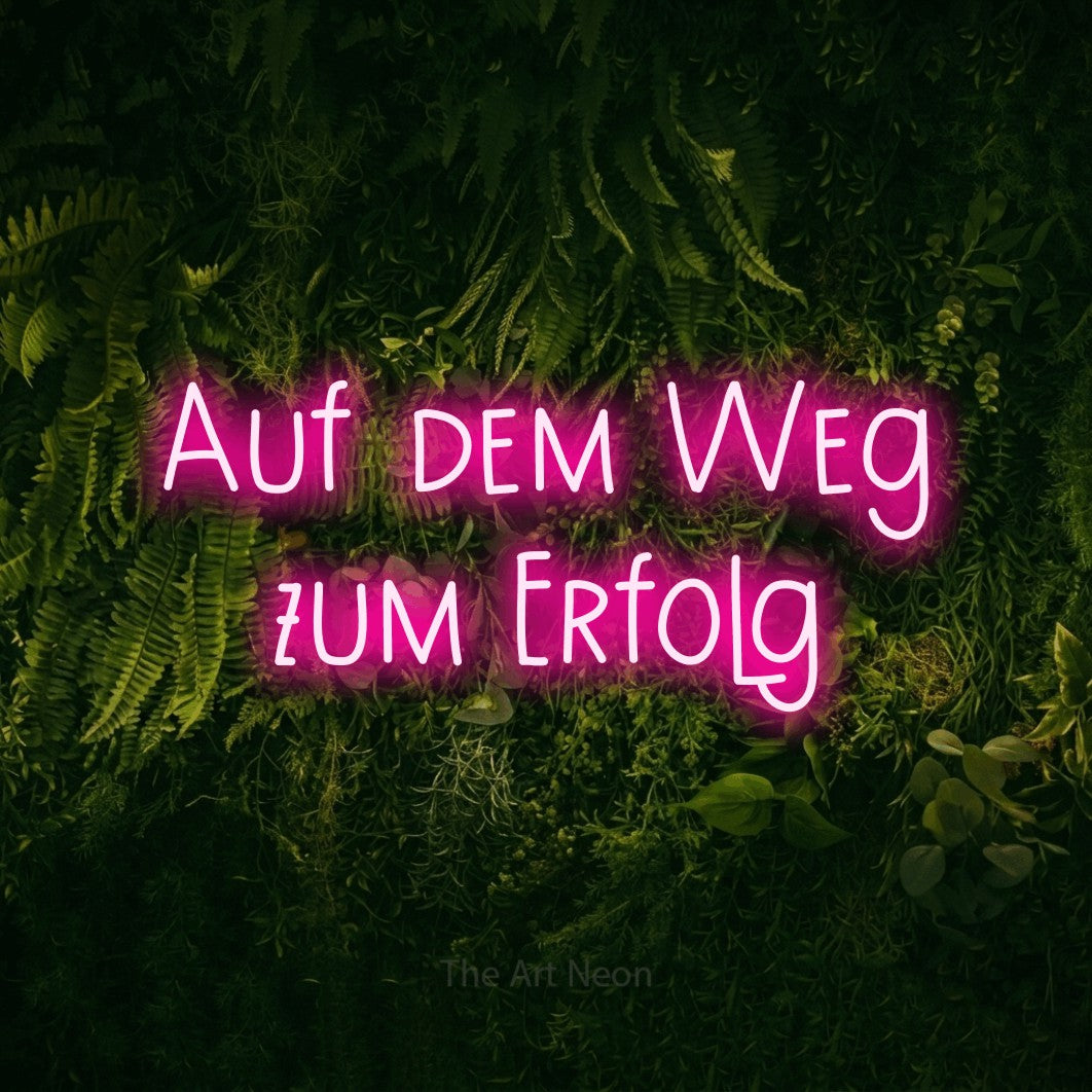 LED neon sign reading “Auf dem Weg zum Erfolg”, arranged in 2 lines.