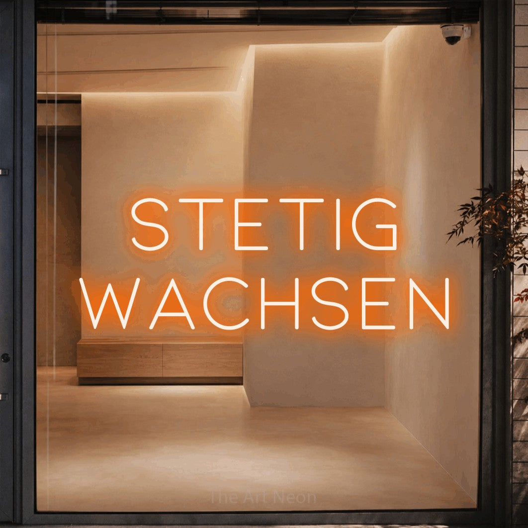 LED neon sign reading “STETIG WACHSEN”, arranged in 2 lines.