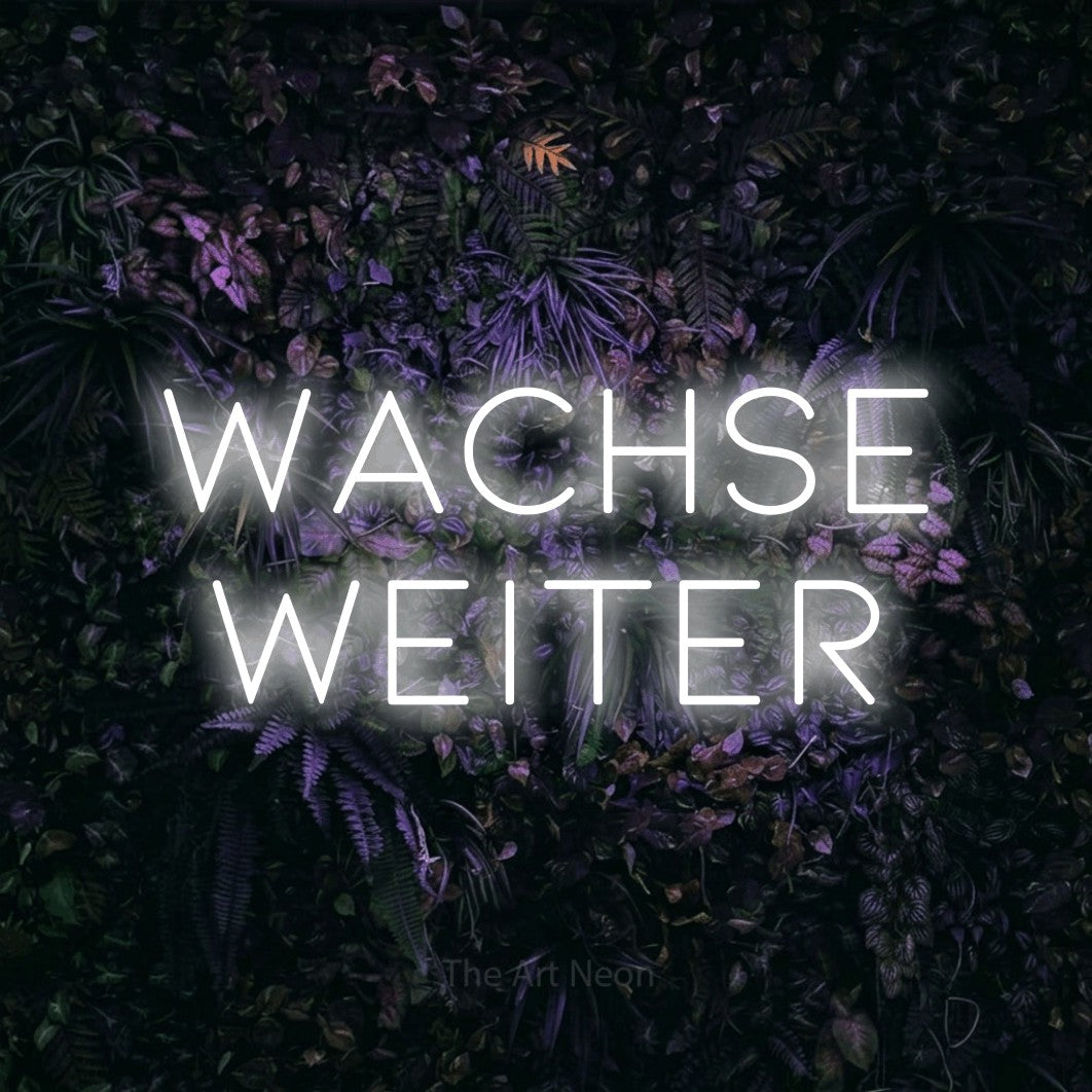 LED neon sign reading “Wachse weiter”, arranged in 2 lines.